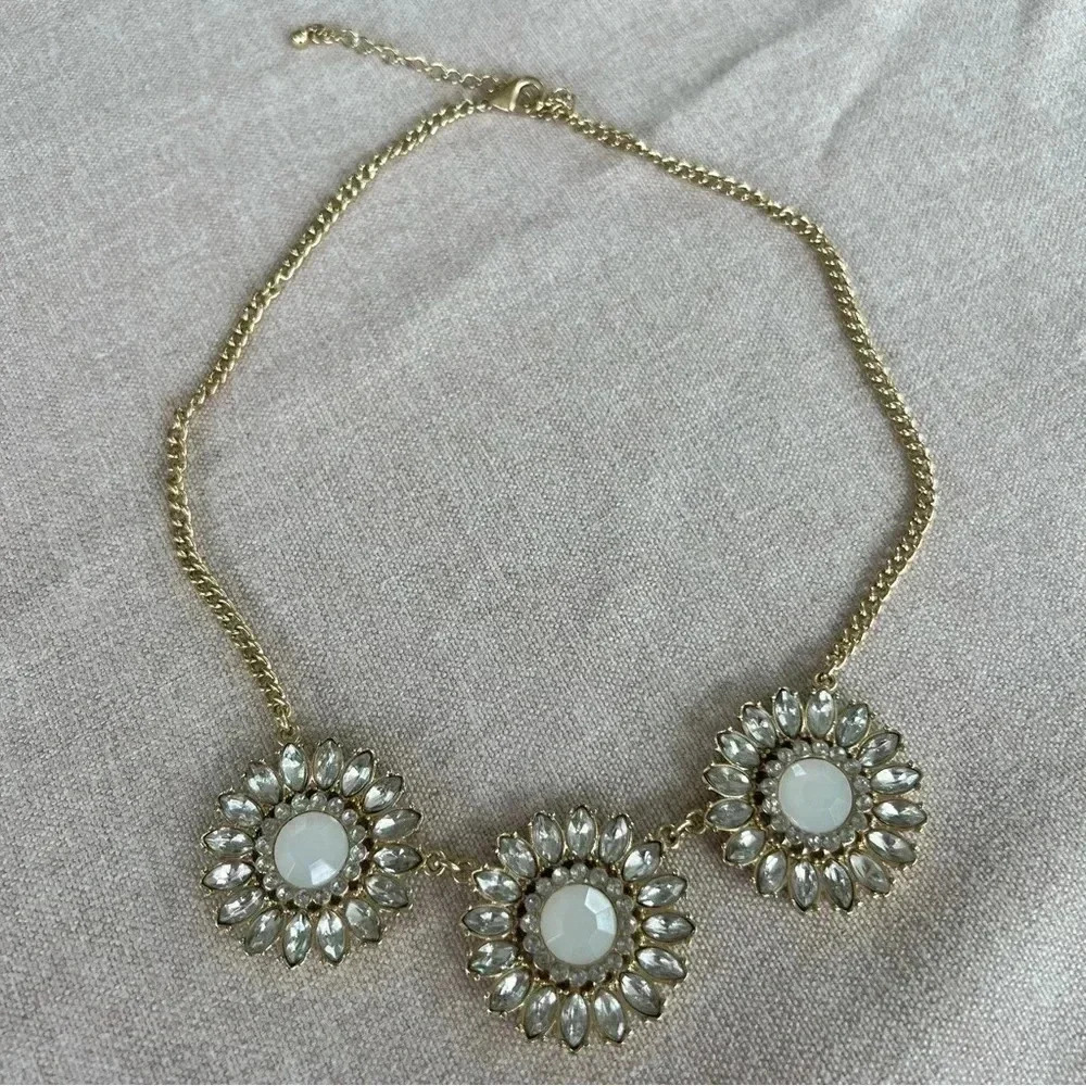 Gold statement necklace with jeweled medallions.
